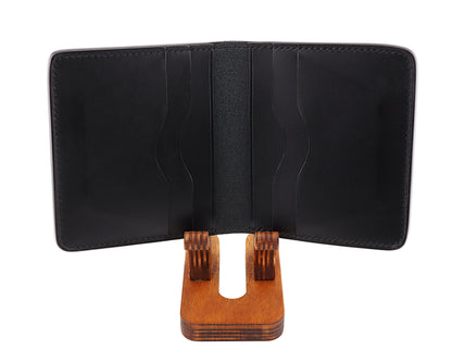 Black leather wallet on a wooden stand with a white background