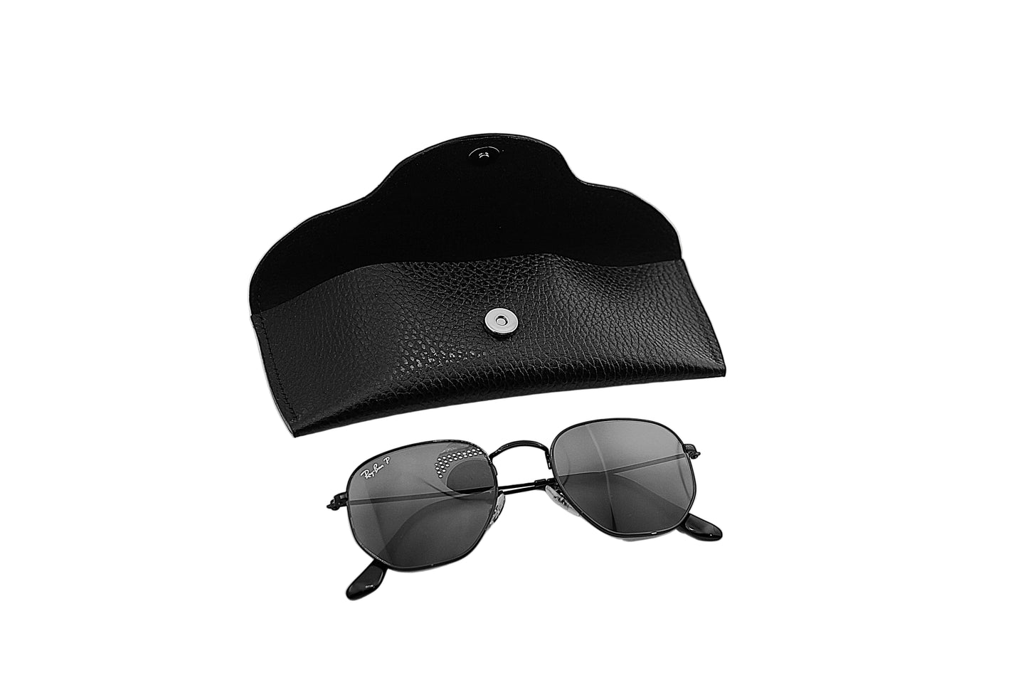 Black sunglasses and black case on a light gray background