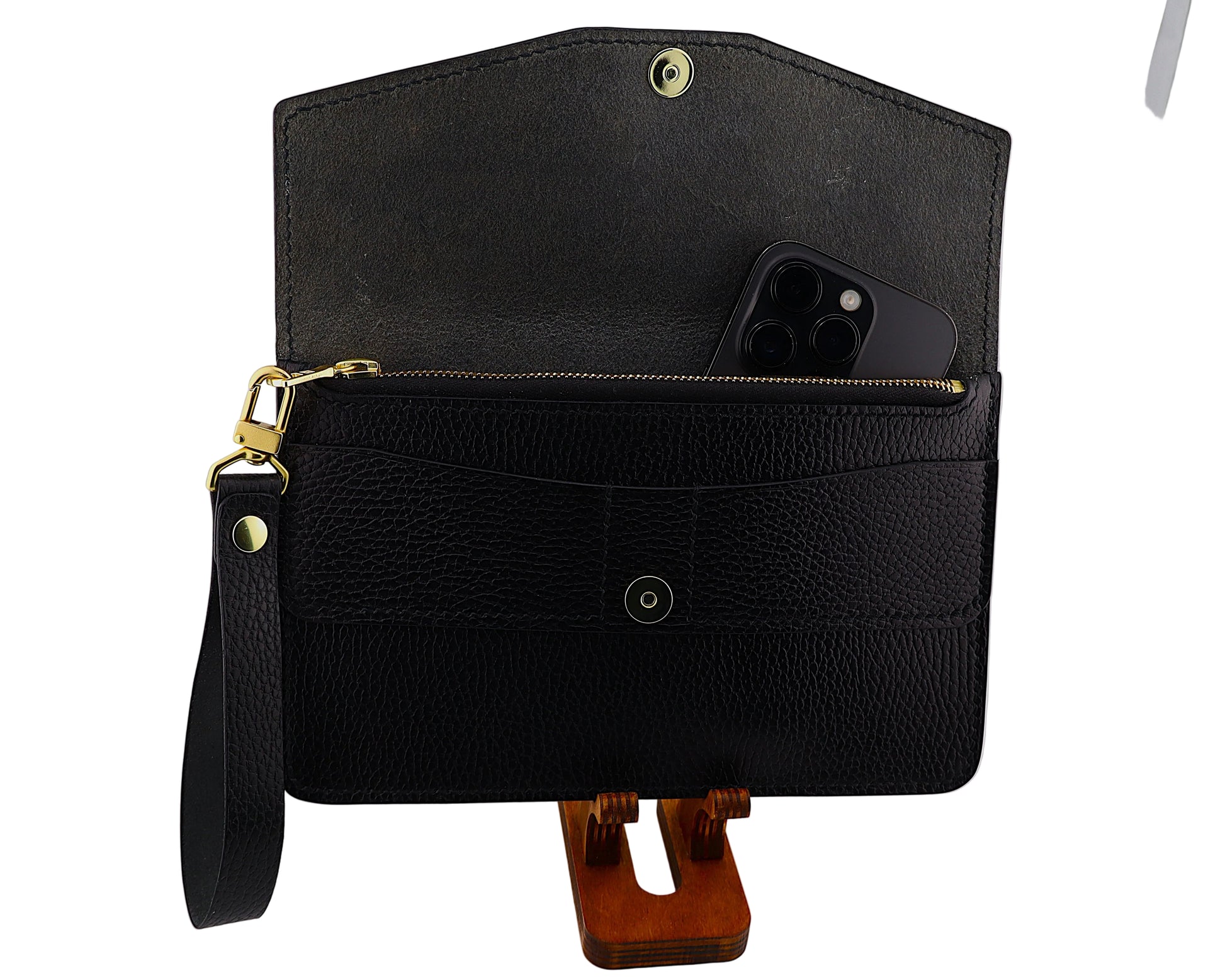 Black leather clutch with a strap on a white background