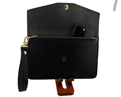 Black leather clutch with a strap on a white background