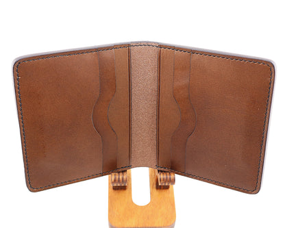 Brown leather wallet on a wooden stand against a white background