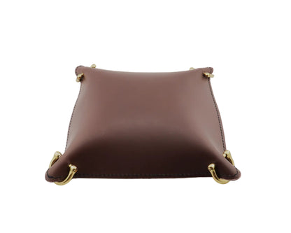 Brown leather tray with gold accents on a light gray background