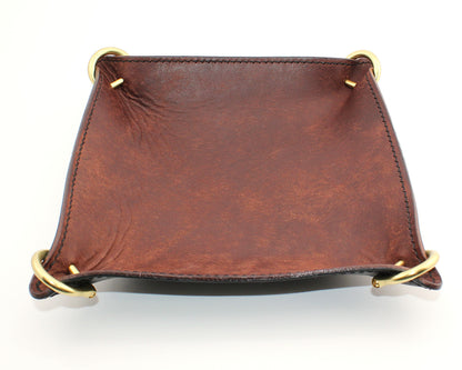 Brown leather tray with gold accents on a white background